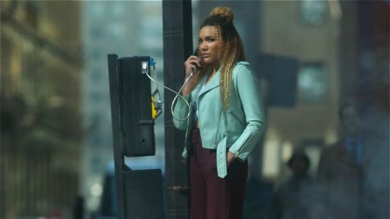 Allison uses a pay phone