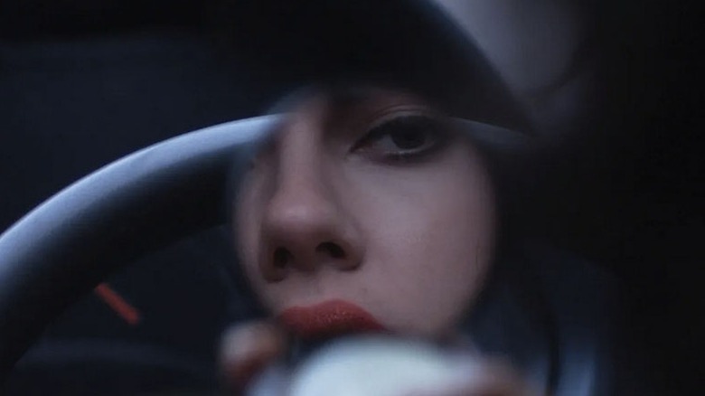 Scarlett Johansson looking at her reflection in Under the Skin