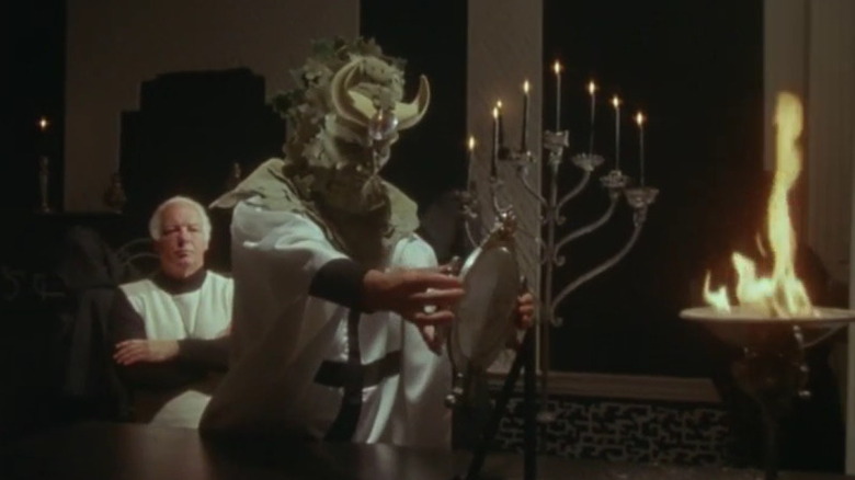 Priest wearing creature mask Hammer House of Horror