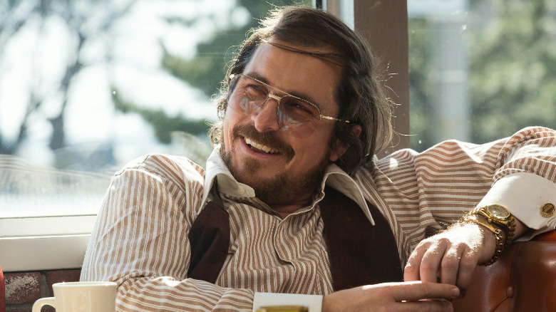 Christian Bale smiling in American Hustle 