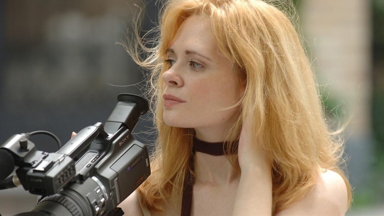 Adrienne Shelly holding a camera