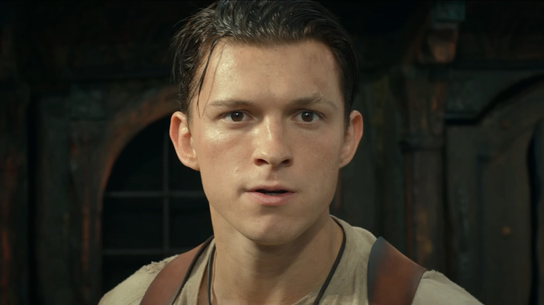 Tom Holland's Nathan Drake looks off into the distance in close-up in Uncharted