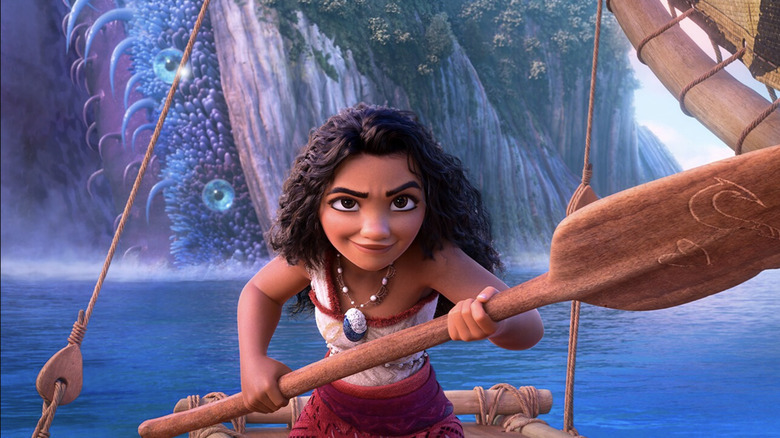 Moana holding up an oar on her canoe in Moana 2