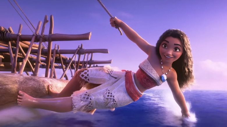 Moana hangs off the side of her canoe with her hand in the water in Moana 2