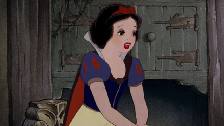 Snow White, sitting in front of a cupboard, looking sad in Snow White and the Seven Dwarfs