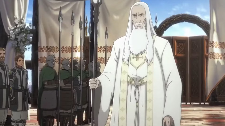 Saruman standing next to a line of soldiers in The Lord of the Rings: The War of the Rohirrim