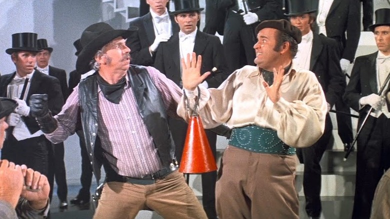 Dom DeLuise as Buddy Bizarre fends off a cowboy's punch in Blazing Saddles