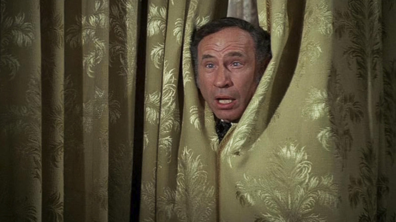 Mel Brooks as Governor William J. Le Petomane pops his head through a curtain in Blazing Saddles