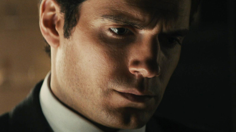 Henry Cavill's Napoleon Solo looks down in close-up in The Man From UNCLE