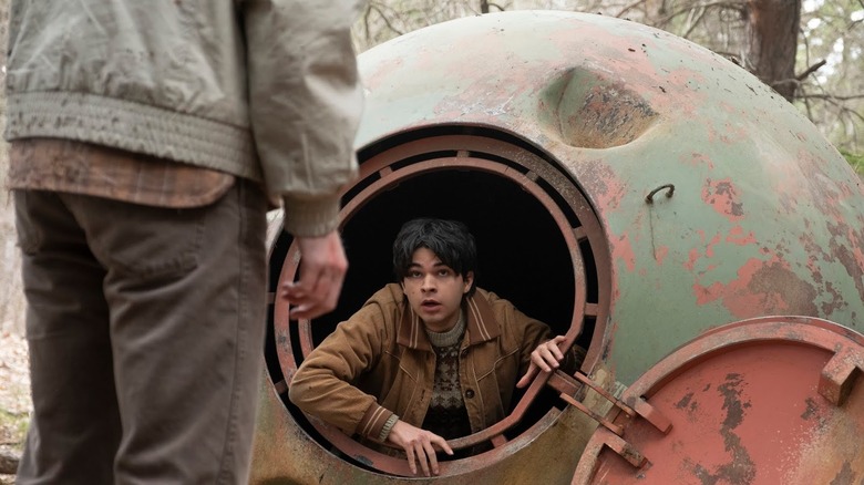 A young man hiding out inside a robot shell in Tales from the Loop