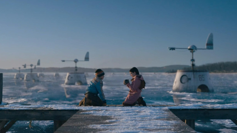 Two children playing on an icy dock