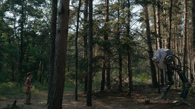 A boy confronting a mysterious robot in the woods