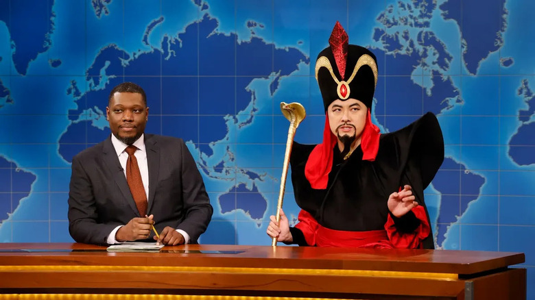 Bowen Yang as Jafar from Aladdin on Saturday Night Live's weekend update desk.