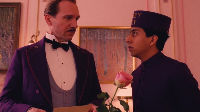 Ralph Fiennes' Gustave H. and Tony Revolori's Zero Moustafa share a look in The Grand Budapest Hotel