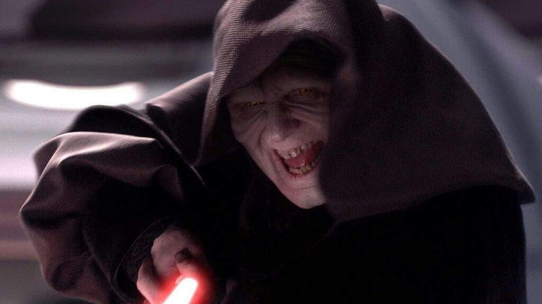 Darth Sidious laughing and pointing lightsaber