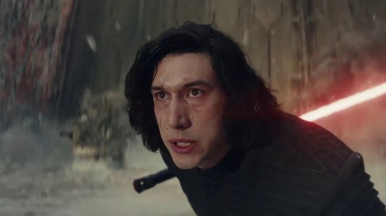 Kylo Ren angrily holding weapon upside down