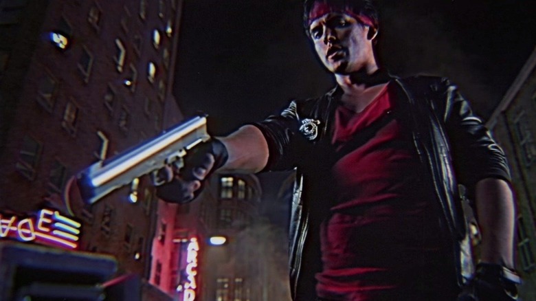 David Sandberg brandishes a pistol in the middle of the street in Kung Fury