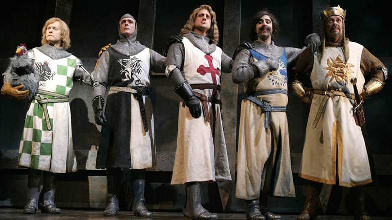 David Hyde Pierce, Hank Azaria, and Tim Curry on stage dressed as knights