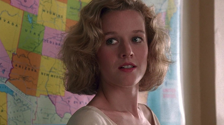 Penelope Ann Miller as Joyce in front of a map in her classroom in Kindergarten Cop