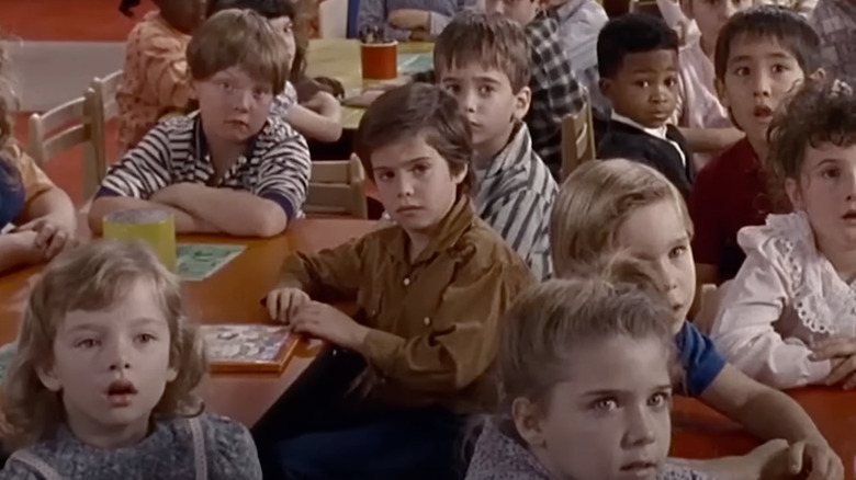 Ross Malinger as Harvey sits with a bunch of kids in Kindergarten Cop