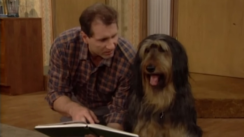 Ed O'Neill as Al Bundy reading to Buck the Dog on Married with Children