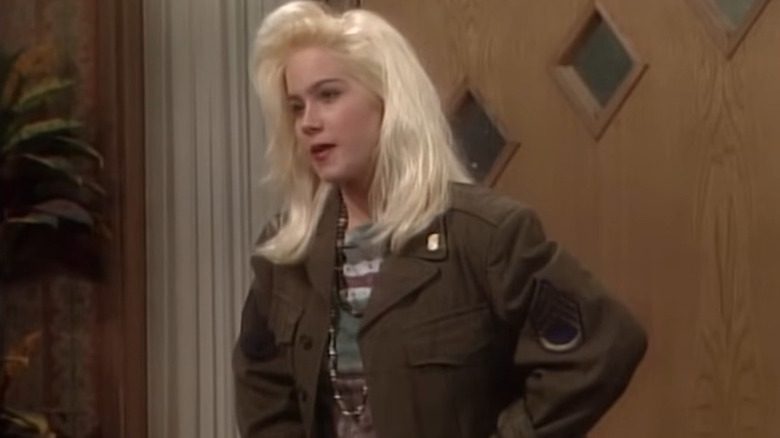 Christina Applegate as Kelly Bundy standing in front of the doorway on Married with Children