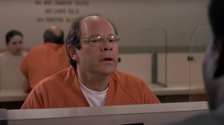 Ethan Phillips as Roger Merman in prison jumpsuit in Bad Santa