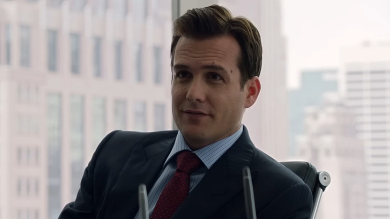 Gabriel Macht as Harvey Specter smiling in his chair on Suits