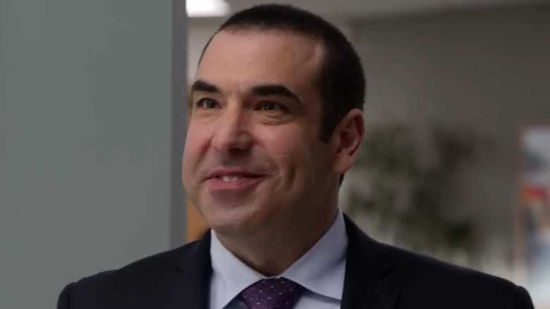 Rick Hoffman as Louis Litt smiling on Suits