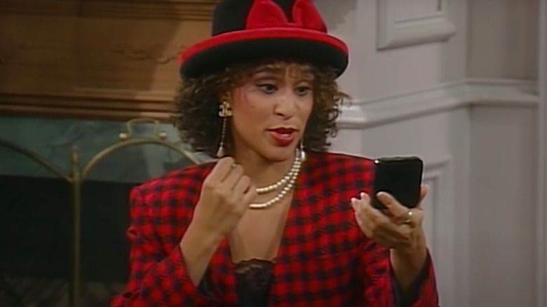 Karyn Parsons as Hilary Banks looks at herself in a mirror in The Fresh Prince of Bel-Air