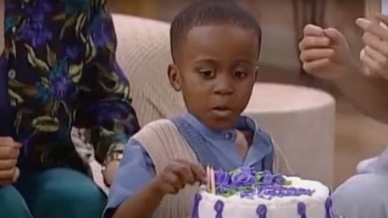 Ross Bagley as Nicky Banks counts candles on a birthday cake in The Fresh Prince of Bel-Air