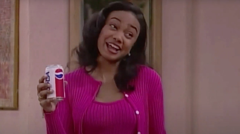 Tatyana Ali as Ashley Banks holds a can of Pepsi on The Fresh Prince of Bel-Air