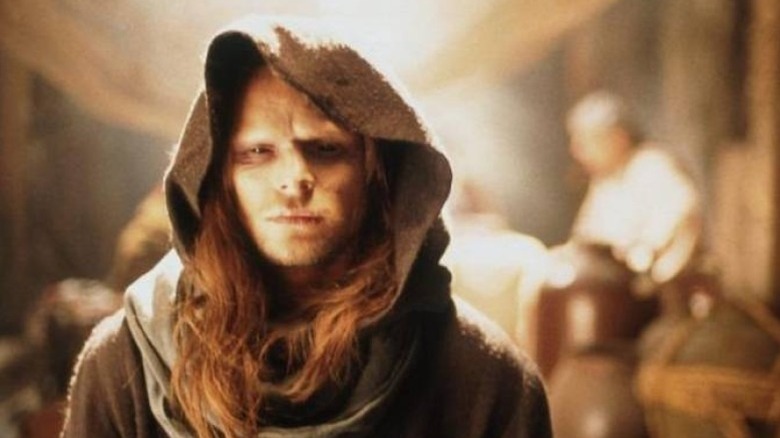 A blind, hooded, Paul Atreides stands concerned in Children of Dune