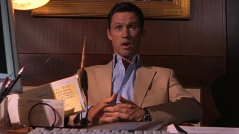 Jeffrey Donovan as Michael Westen sitting behind a desk and talking.