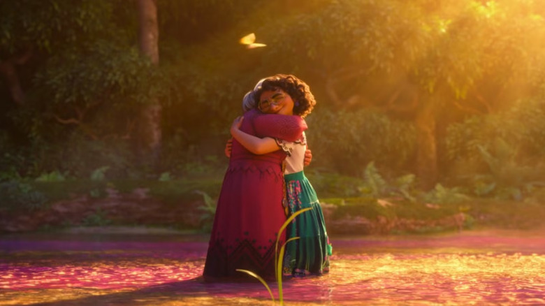 Abuela and Mirabel hugging while standing in a river in Encanto