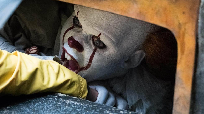 Pennywise preparing to bite off Georgie's arm in It (2017)