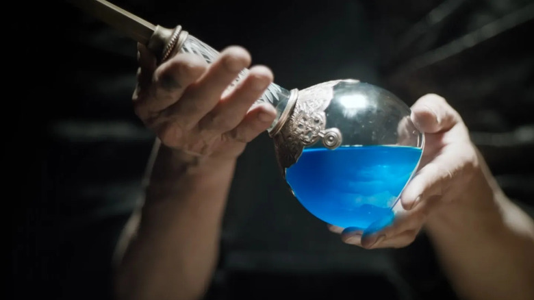 Someone holds a glass item containing live water in Dune: Part Two