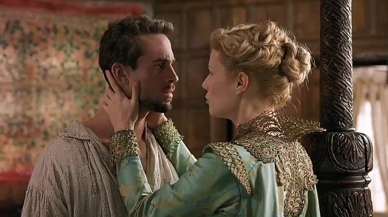 Viola holds William Shakespeare's head in his hands, and they both look worried, in Shakespeare in Loveubov.