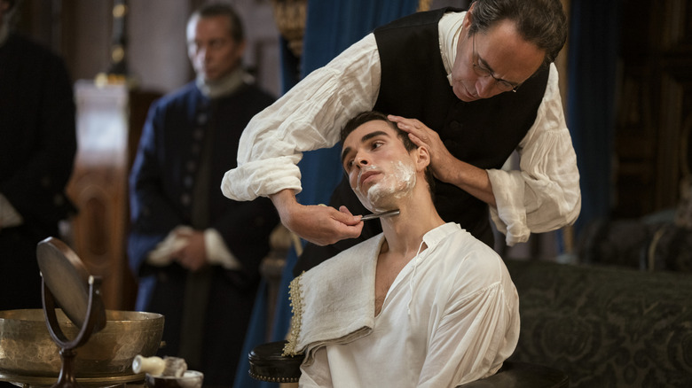 King George getting a shave on Queen Charlotte: A Bridgerton Story