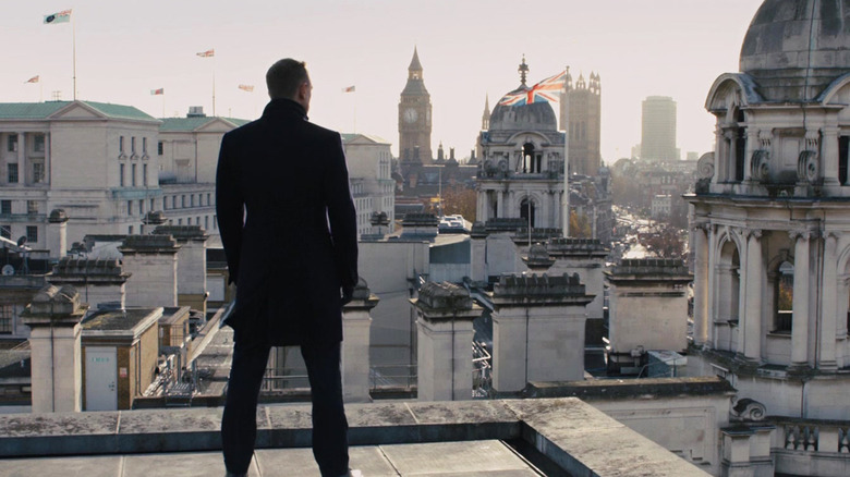 Daniel Craig's James Bond stands on a London rooftop overlooking the city with the Union Jack visible in Skyfall