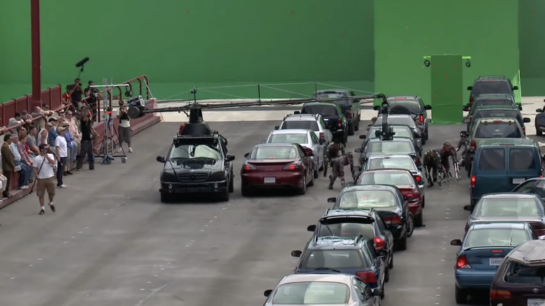 Mocap actors running past cars in front of green screens for Rise of the Planet of the Apes