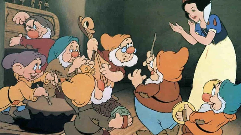 Snow White clapping while the seven dwarfs play musical instruments in Disney's Snow White and the Seven Dwarfs