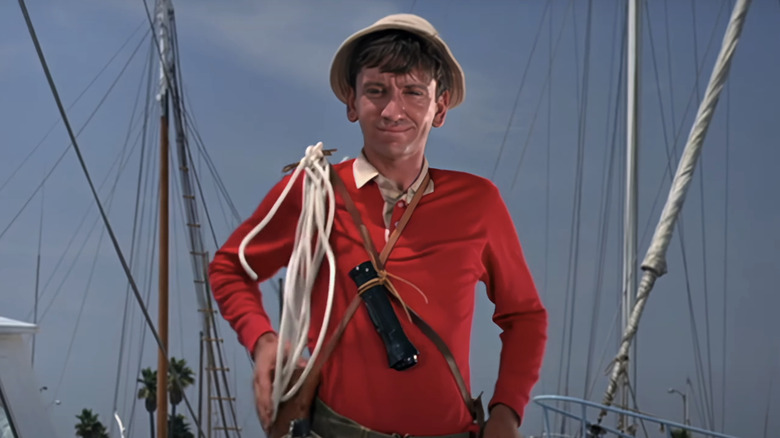 Bob Denver's Giilligan stands in a marina in the opening sequence of Gilligan's Island