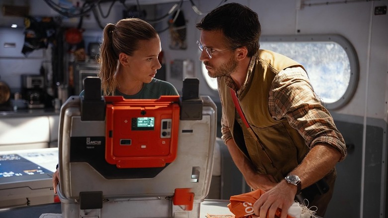 Scarlett Johansson as Zora Bennett and Jonathan Bailey as Dr. Henry Loomis converse on a boat in Jurassic World Rebirth