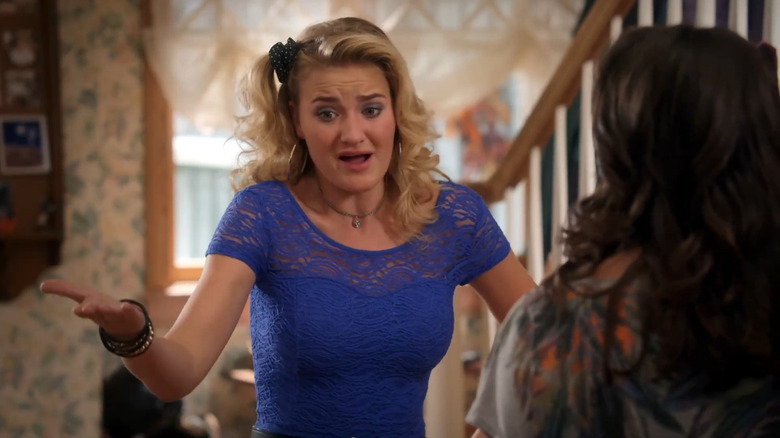 AJ Michalka as Lainey Lewis gesturing in The Goldbergs