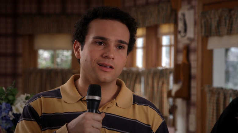 Troy Gentile as Barry Goldberg holding a microphone in The Goldbergs