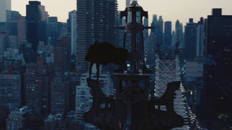 The Dark Knight Rises Batman standing on tower overlooking Gotham City