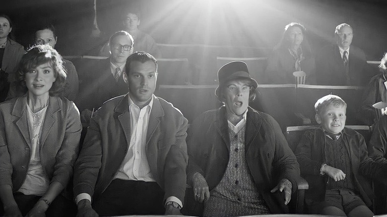 a black and white image of an old time movie theatre audience