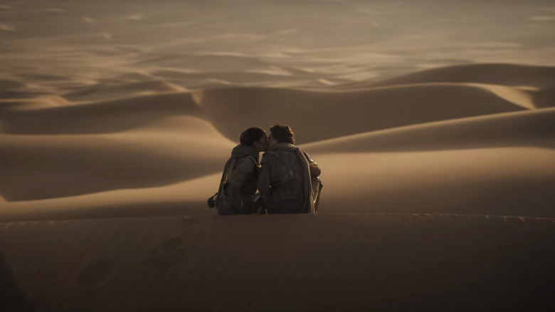 Timothée Chalamet's Paul Atreides and Zendaya's Chani share a kiss atop a sand dune in Dune Part Two