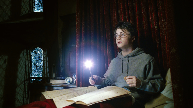 Harry using the Marauder's Map in his dorm in Harry Potter and the Prisoner of Azkaban